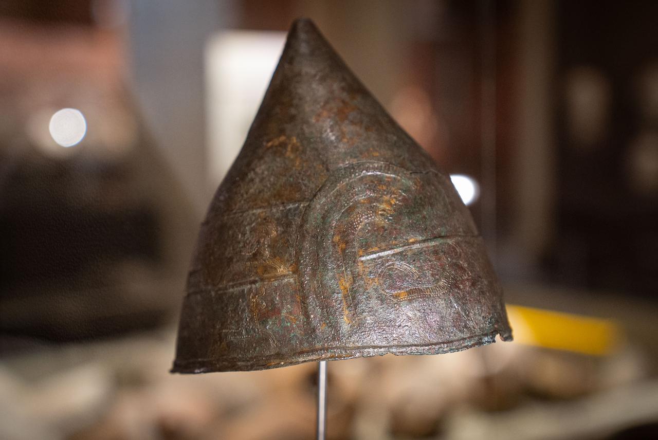 A bronze helmet decorated with mythological figures, unearthed from the Haldi Temple in Van, is displayed at the “Golden Age of Archaeology” exhibition at the Presidential Library in Ankara, Türkiye, August 9, 2025. (AA Photo)