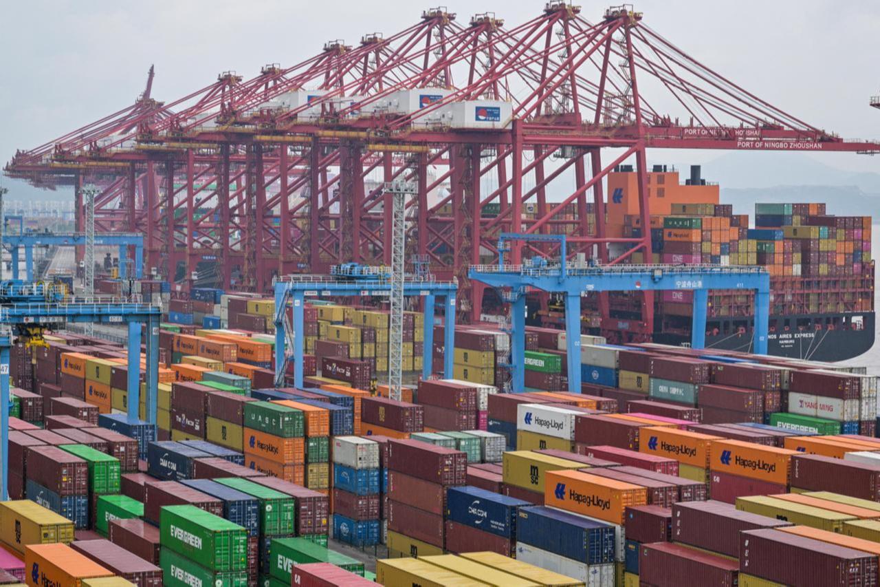 A cargo ship is seen past containers at the Port of Ningbo-Zhoushan in Ningbo, in Chinas eastern Zhejiang Province, May 28, 2025. (AFP Photo)
