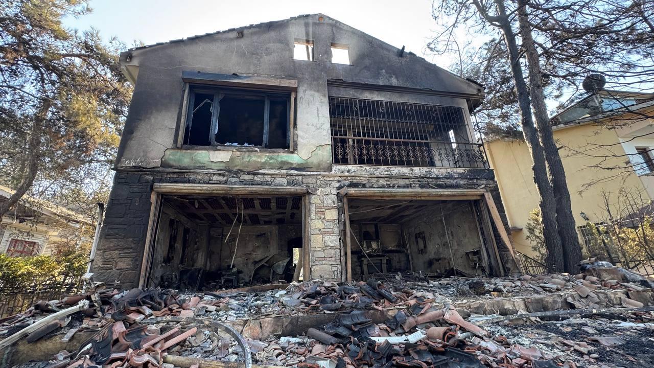 Damaged house is seen after a forest fire, which has been burning for a second day, spread rapidly due to strong winds in Kepez town, causing significant damage to summer homes in Guzelyali village and rendering several parked vehicles unusable in Canakkale, Turkiye, on August 12, 2025. (AA Photo)