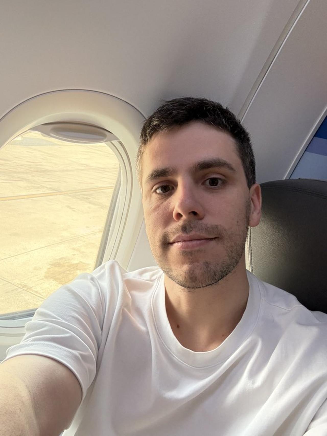 Federico Carrone takes a selfie on a plane after leaving Türkiye following his release from detention, August 11, 2025. (Photo via X/@fede_intern)