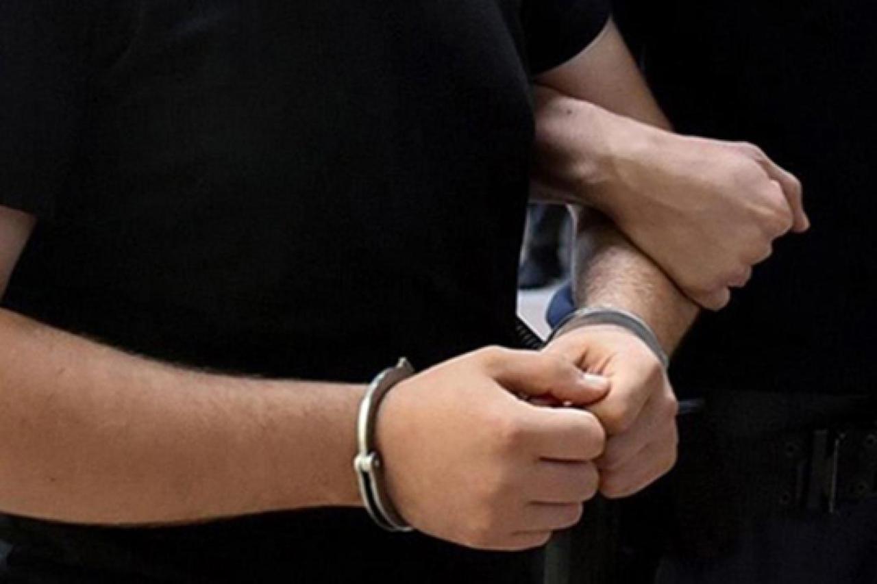 A person in handcuffs is escorted by a law enforcement officer during a detention in Türkiye. (AA Photo)