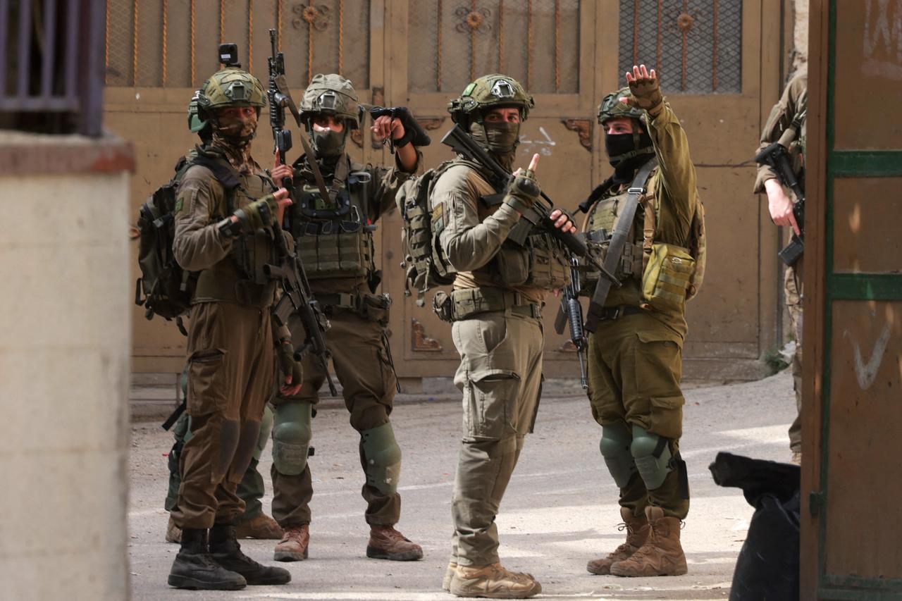 Israeli soldiers gesture during a raid at the Balata refugee camp east of Nablus city in the occupied West Bank, Palestine, August 11, 2025. (AFP Photo)