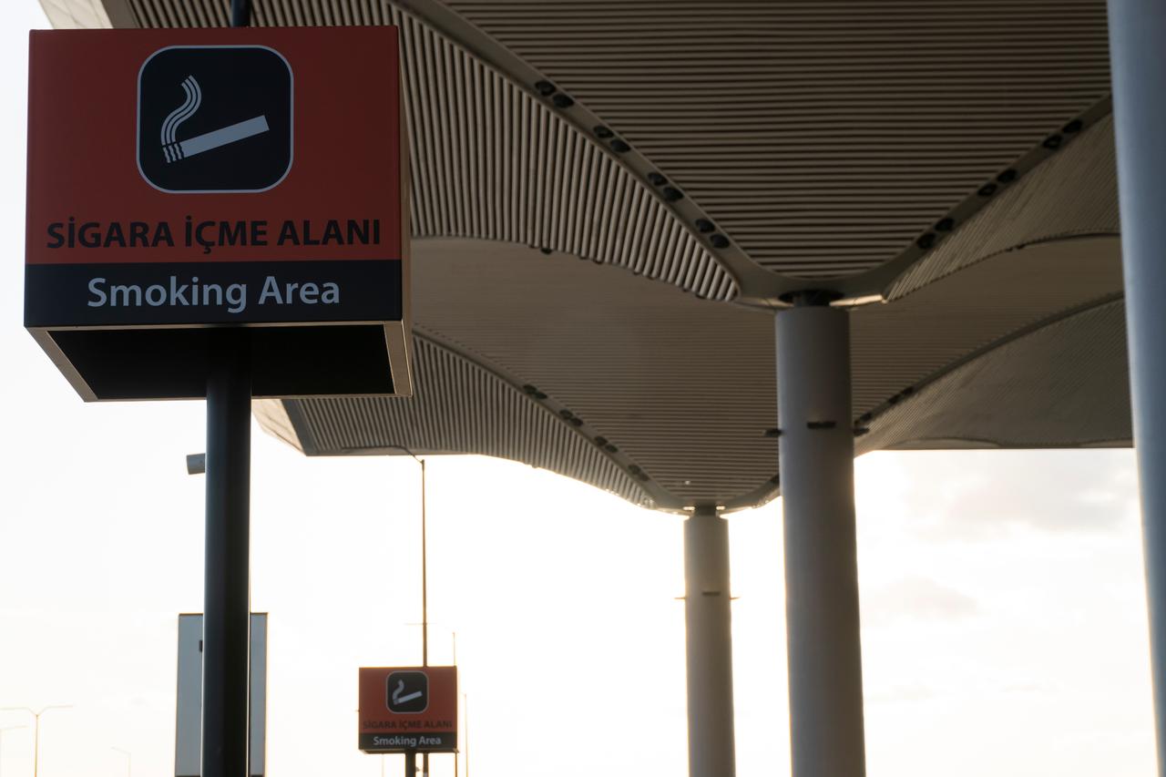 A smoking area sign is displayed at Istanbul Airport, Türkiye. (Adobe Stock Photo)