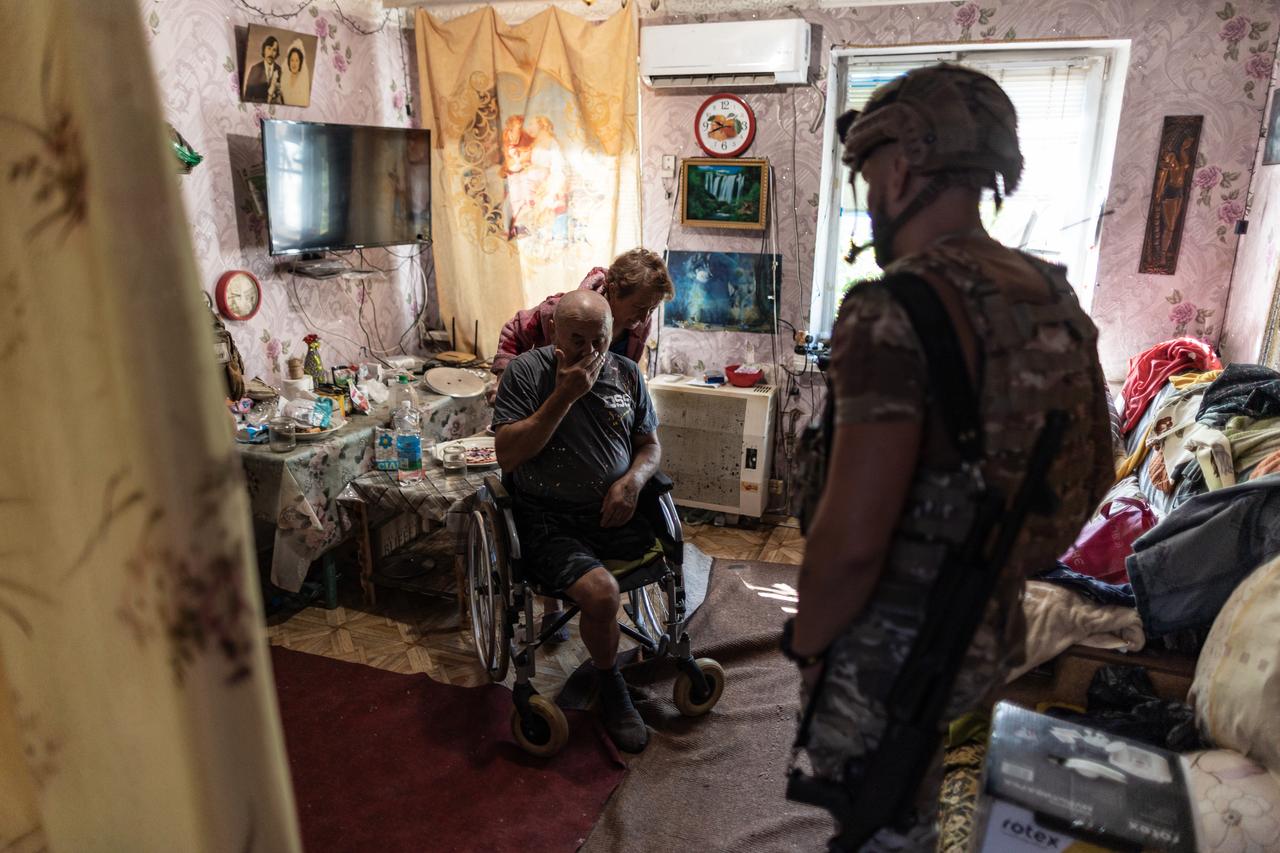 The ‘White Angels’ police group evacuates a couple from the village of Andriivka, following the advance of Russian troops, in the Donetsk Oblast, Ukraine, 13 August 2025. (AA Photo)