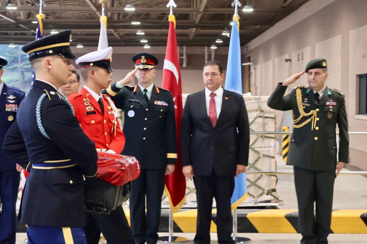 Türkiyes Ambassador to Seoul, Murat Tamer (right 2), with bodies of the four killed Turkish soldiers, wrapped in the Turkish flag being handed over in a ceremony on 15 August, 2025. (AA Photo)