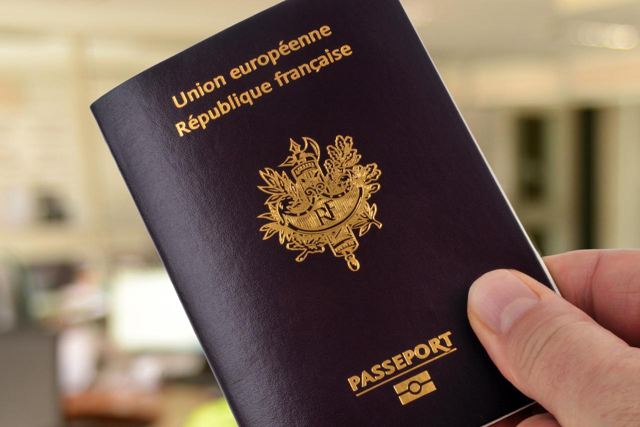 French biometric passport held in hand close-up. (Adobe Stock Photo)