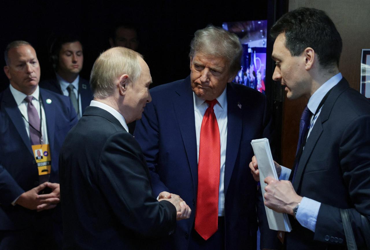 US President Donald Trump (C) and Russian President Vladimir Putin (L) shake hands after delivering a joint press conference at Joint Base Elmendorf-Richardson in Anchorage, Alaska, on August 15, 2025. (AFP Photo)
