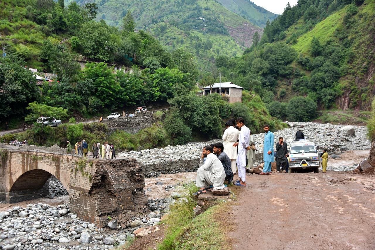 Onlookers gather near a destroyed bridge after flash floods on the outskirts of Muzaffarabad, the capital of Pakistan-administered Kashmir, on August 15, 2025. (AFP Photo)