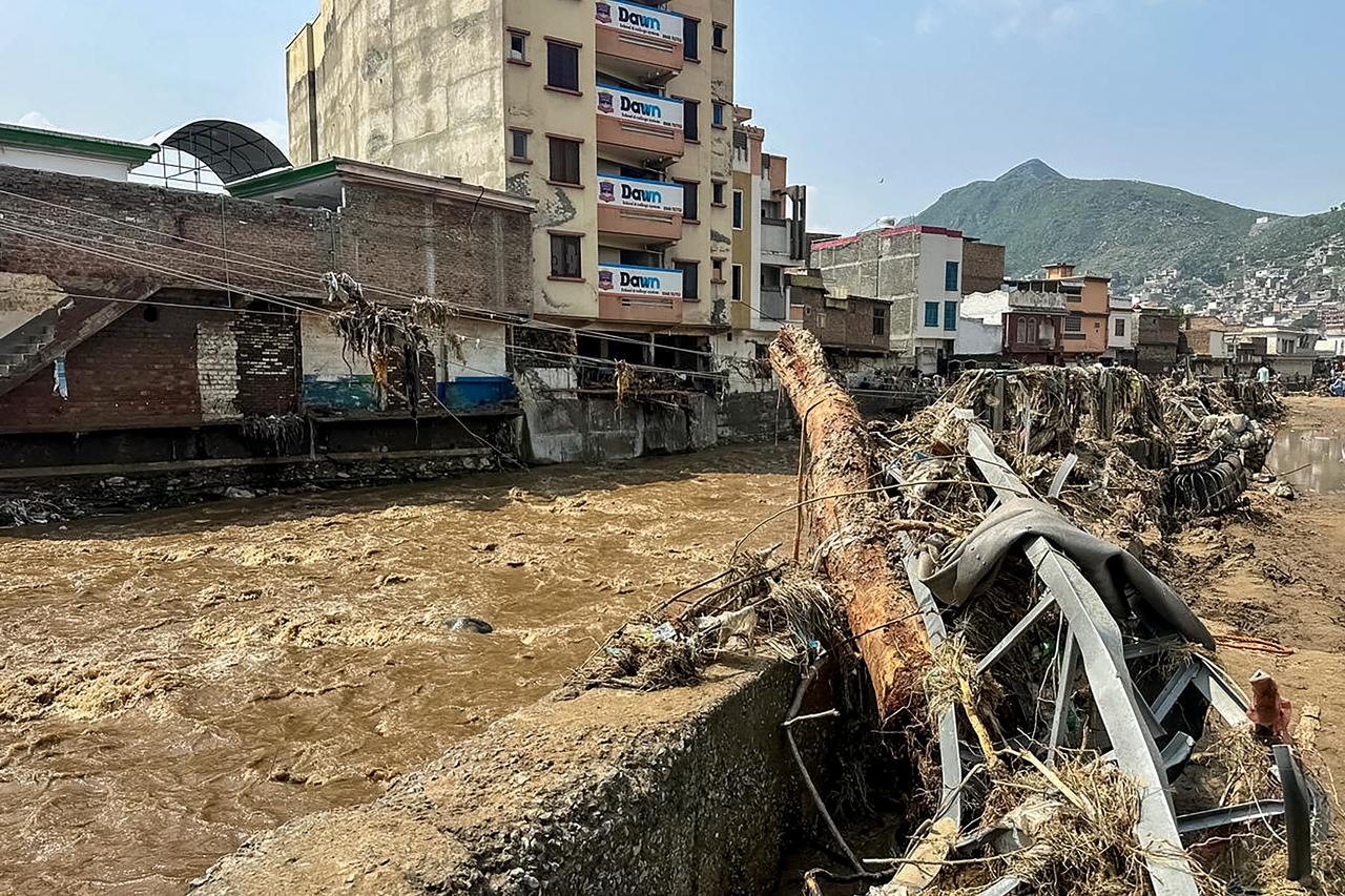 Floodwater flows near a damaged market following a flash flood in Mingora, the main city of Swat Valley, in monsoon-hit northern Pakistan's mountainous Khyber Pakhtunkhwa province on August 16, 2025. (AFP Photo)