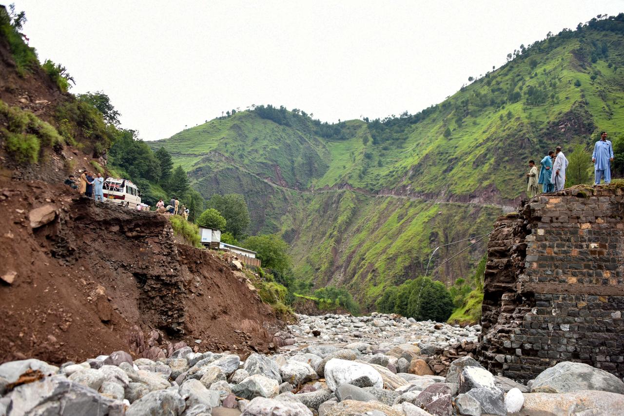 Onlookers gather near a destroyed bridge after flash floods on the outskirts of Muzaffarabad, the capital of Pakistan-administered Kashmir, on August 15, 2025. (AFP Photo)