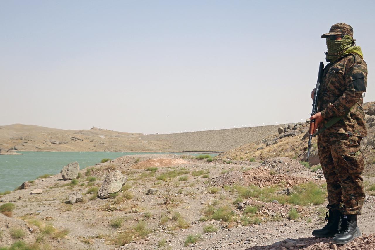 A Taliban security personnel stands guard near the Pashdan Dam, also known as Band-e Pashdan, after the inauguration of its power station in Herat province, Afghanistan, Aug. 14, 2025. (AFP Photo)