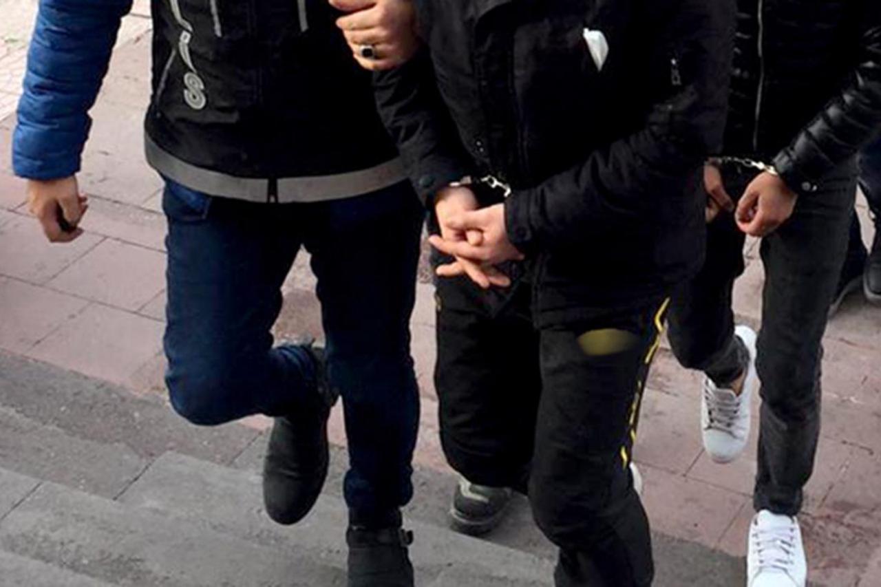 File photo shows Turkish police officers escorting suspects in handcuffs during an operation. (AA Photo)