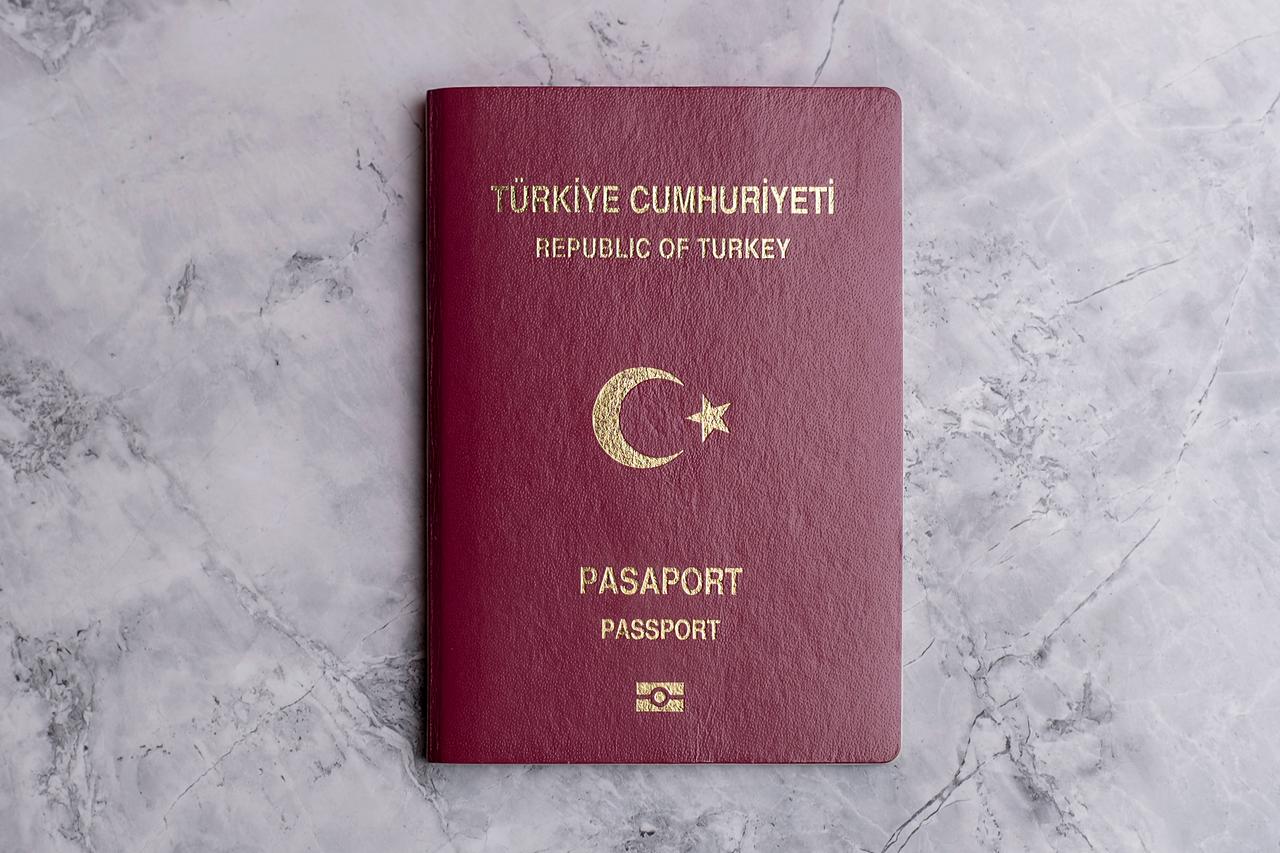 A Turkish passport placed on a sleek marble surface. (Adobe Stock Photo)