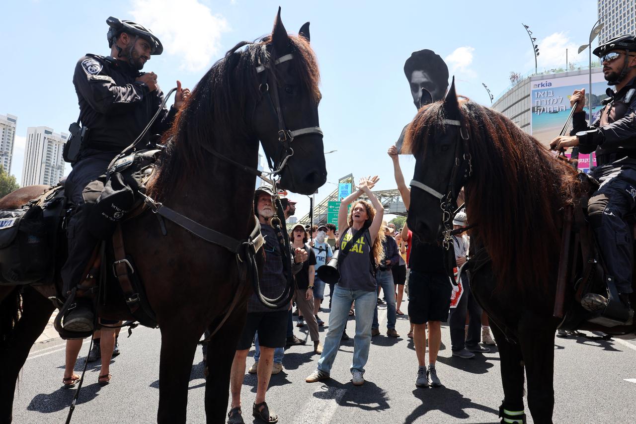 A demonstrator shouts slogans in front of mounted policemen during an anti-government protest demanding a deal to release Israelis detained in the Gaza Strip by Hamas militants since October 7, 2023, in Tel Aviv on August 17, 2025. (AFP Photo)