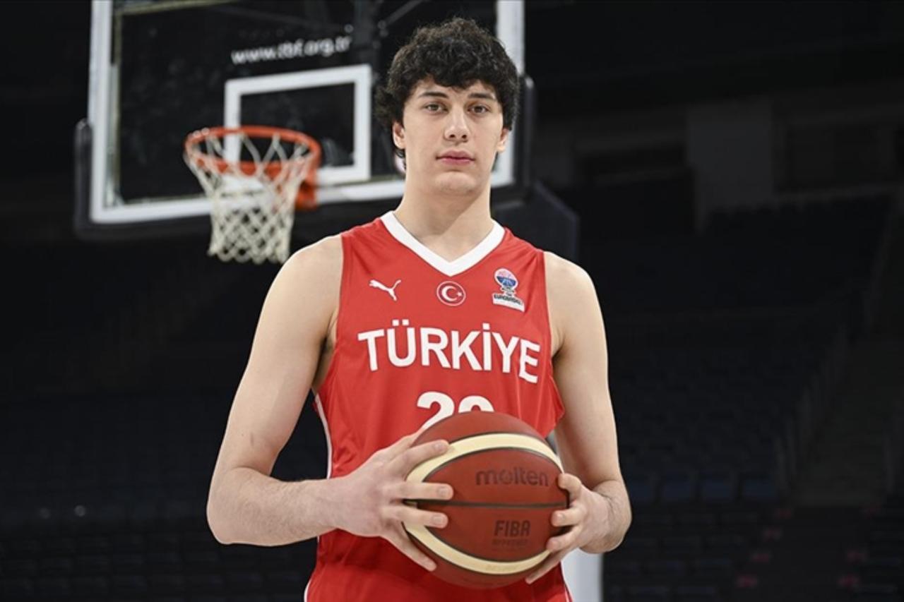 Turkish international Kerem Konan poses with national team jersey and basketball, accessed Aug. 18, 2025. (AA Photo)