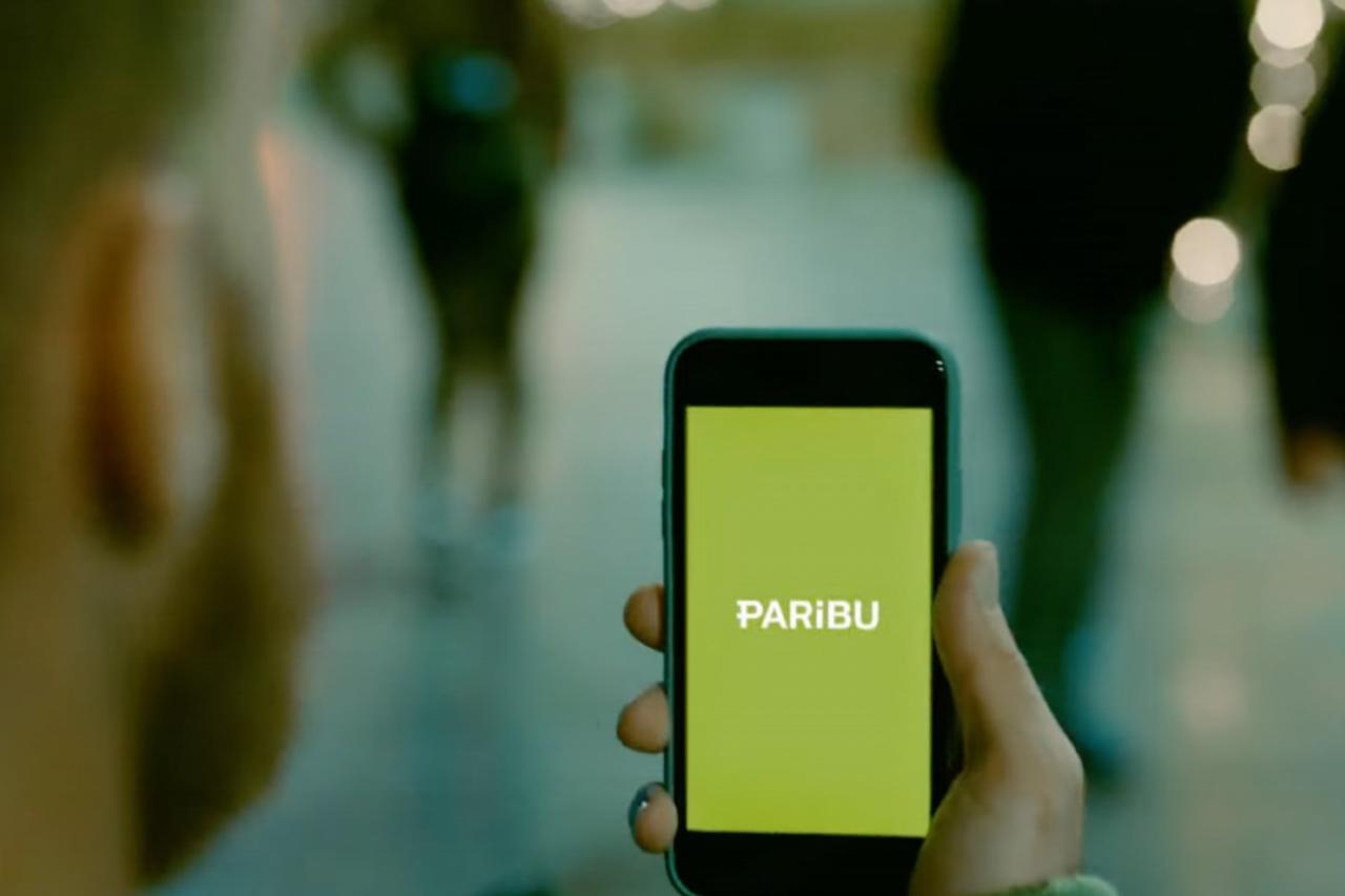 A user holds a smartphone displaying the Paribu logo, (AA Photo)