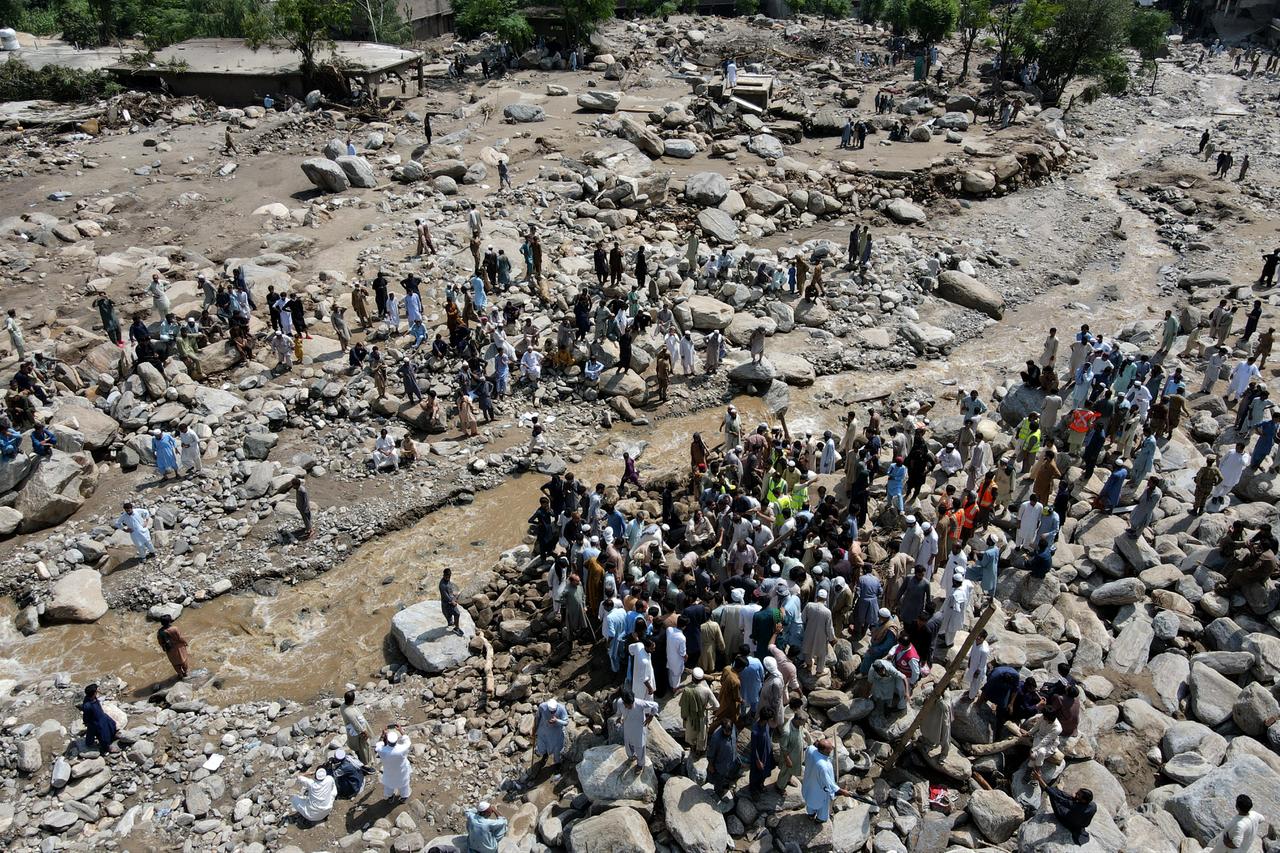 An aerial view shows flood survivors gathered along the banks of a river surrounded by heavy rocks in the Buner district of mountainous Khyber Pakhtunkhwa province, Pakistan, August 17, 2025. (AFP Photo)