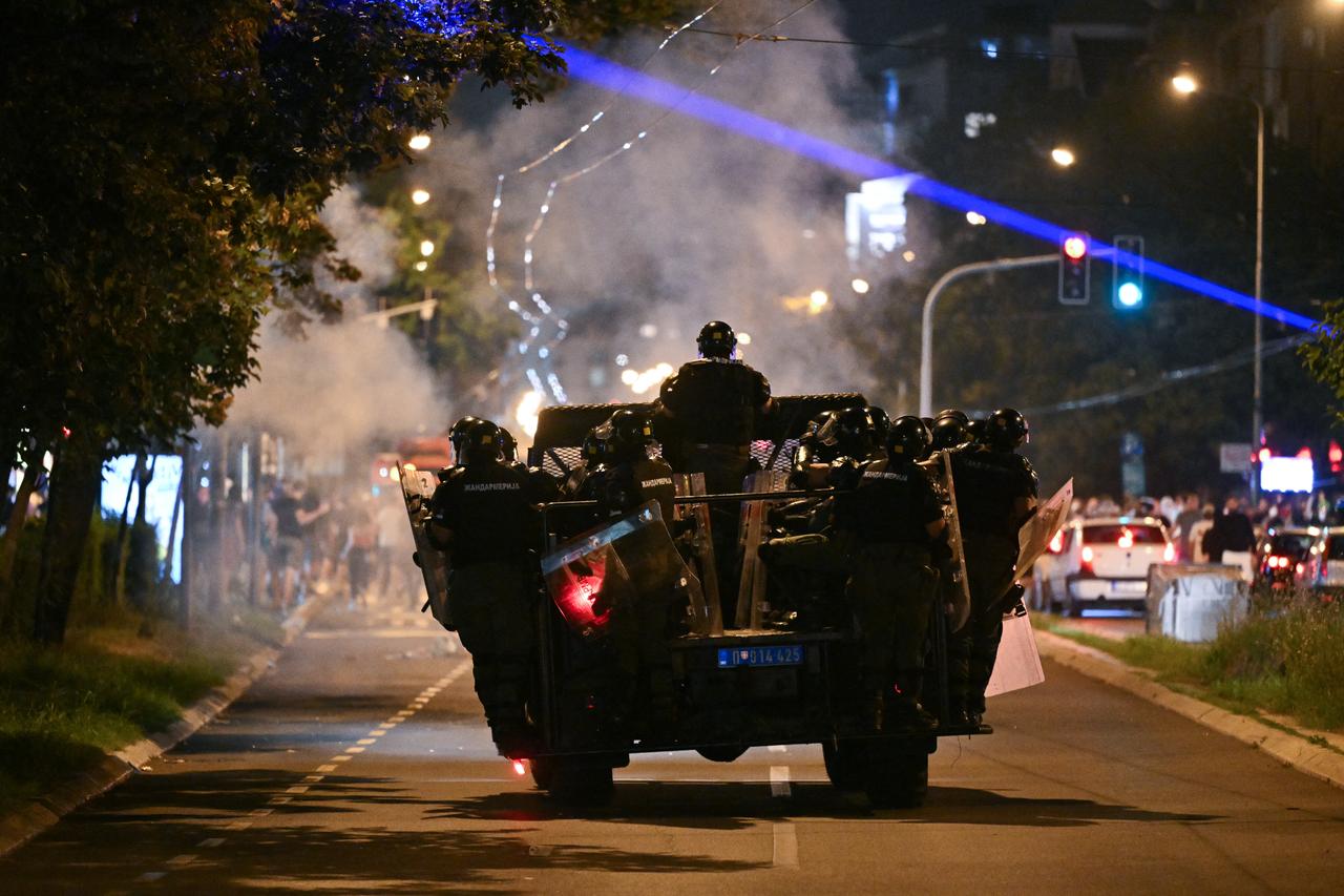 Serbian riot police officers travel on the back of a vehicle as they face protestors during ongoing anti-government protests in Belgrade, Serbia, August 18, 2025. (AFP Photo)