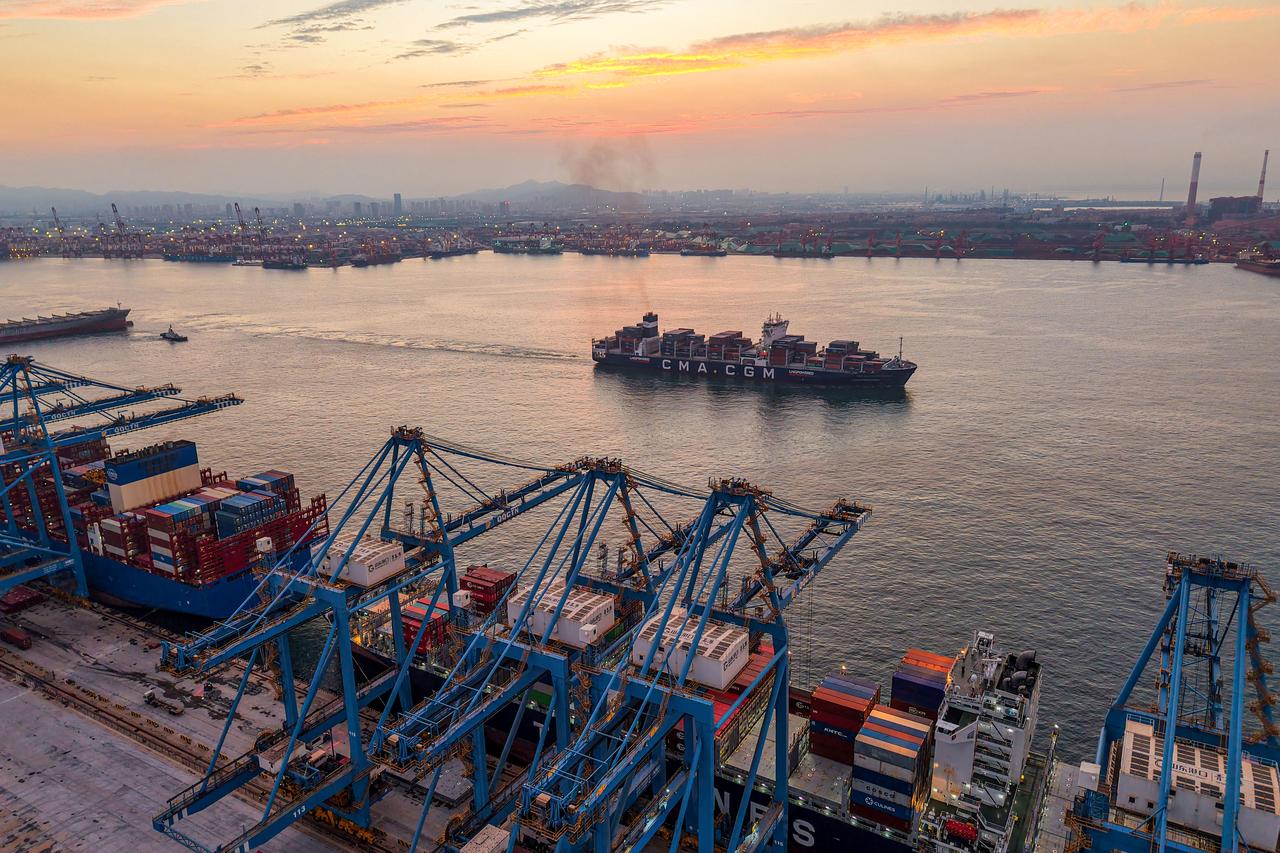 A container ship sails out of the port in Qingdao, in China’s eastern Shandong province during sunset on August 13, 2025. (AFP Photo)