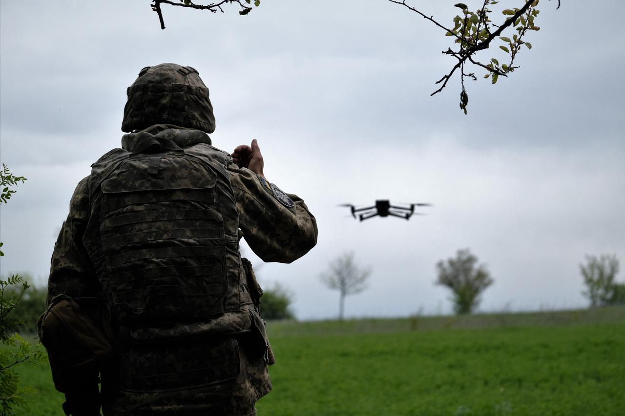 A Ukrainian serviceman of a reconnaissance team flies a drone at a front line near the town of Bakhmut, Donetsk region on May 8, 2023. (AFP Photo)