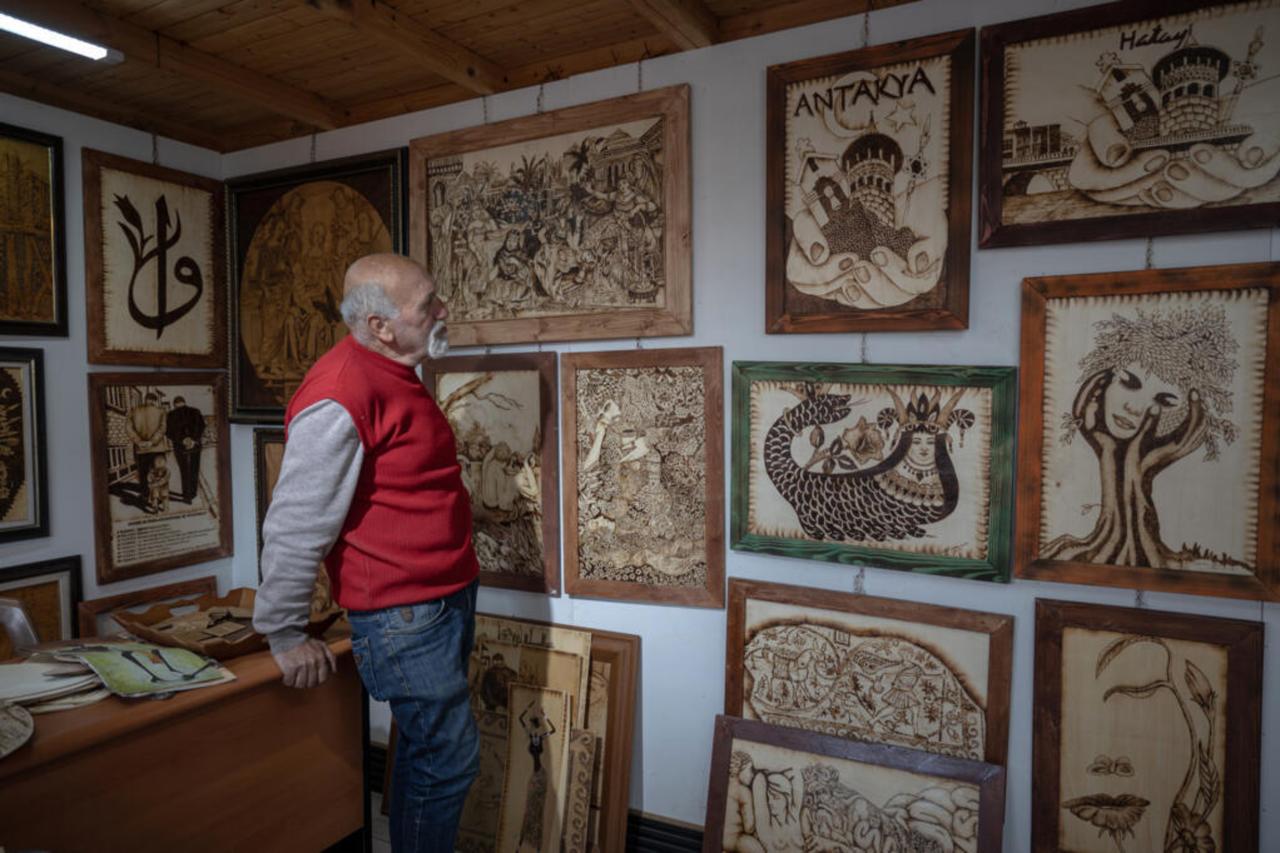 Artist Naim Gulbol poses with his artworks in his workshop at the Antakya Art and Culture Market, January 29, 2025. (AFP Photo)