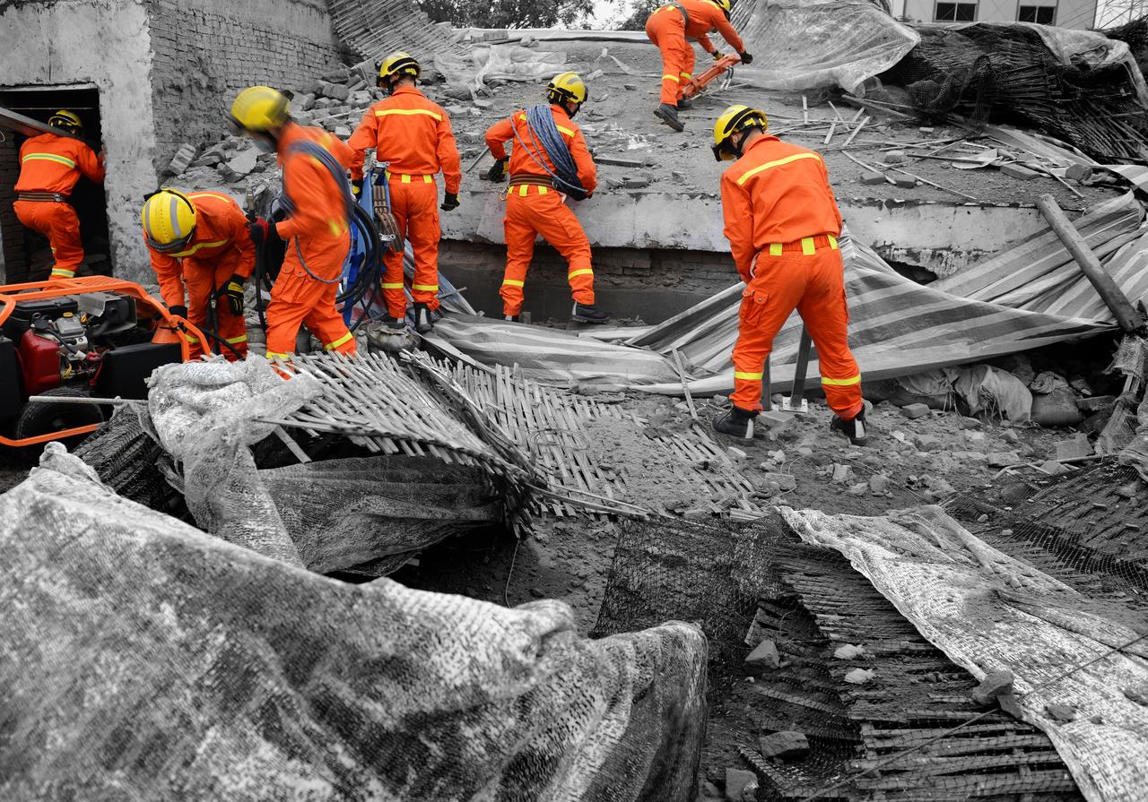 Emergency teams conducting search and rescue operations in a collapsed building after quake. (Adobe Stock Photo)