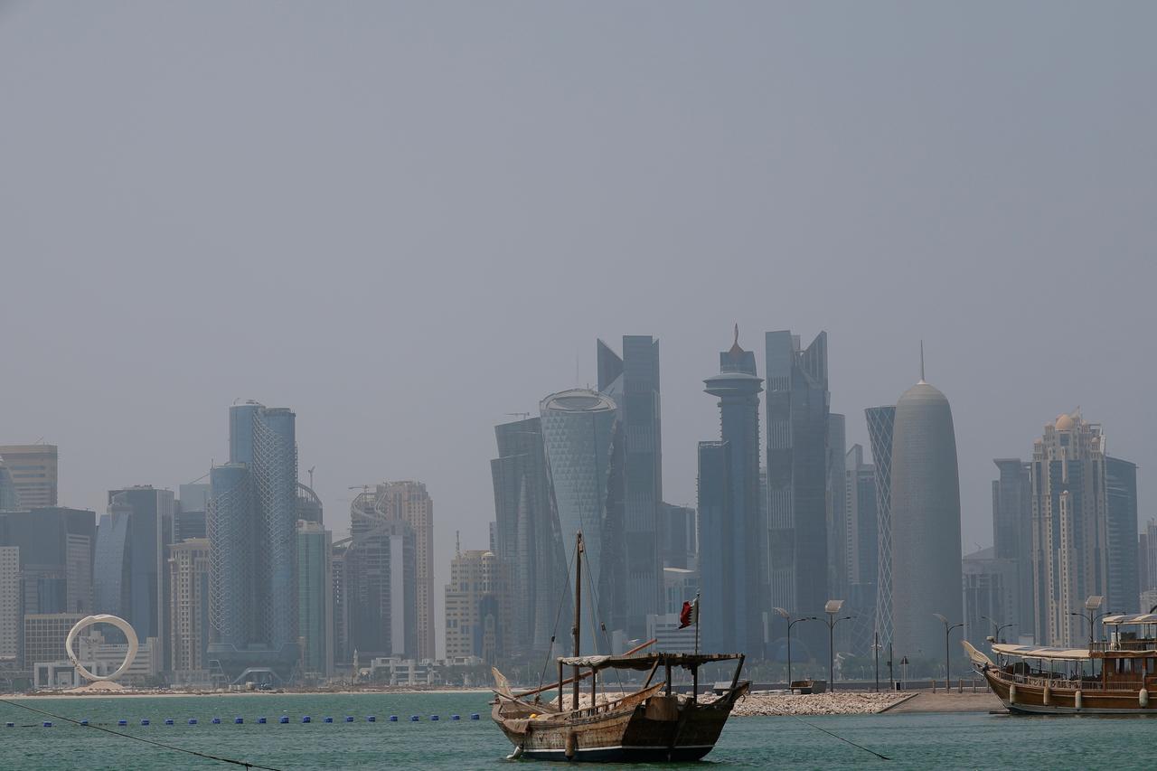 A picture shows a moored dhow with the Doha skyline in the background on a hot and humid summer day on August 6, 2025. (AFP Photo)