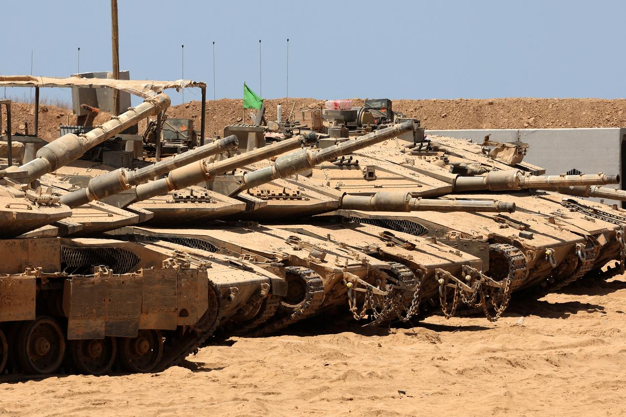 This picture taken from a position at Israel's border with the Gaza Strip shows Israeli tanks deployed in the bordering area of the besieged Palestinian territory on August 19, 2025. (AFP Photo)