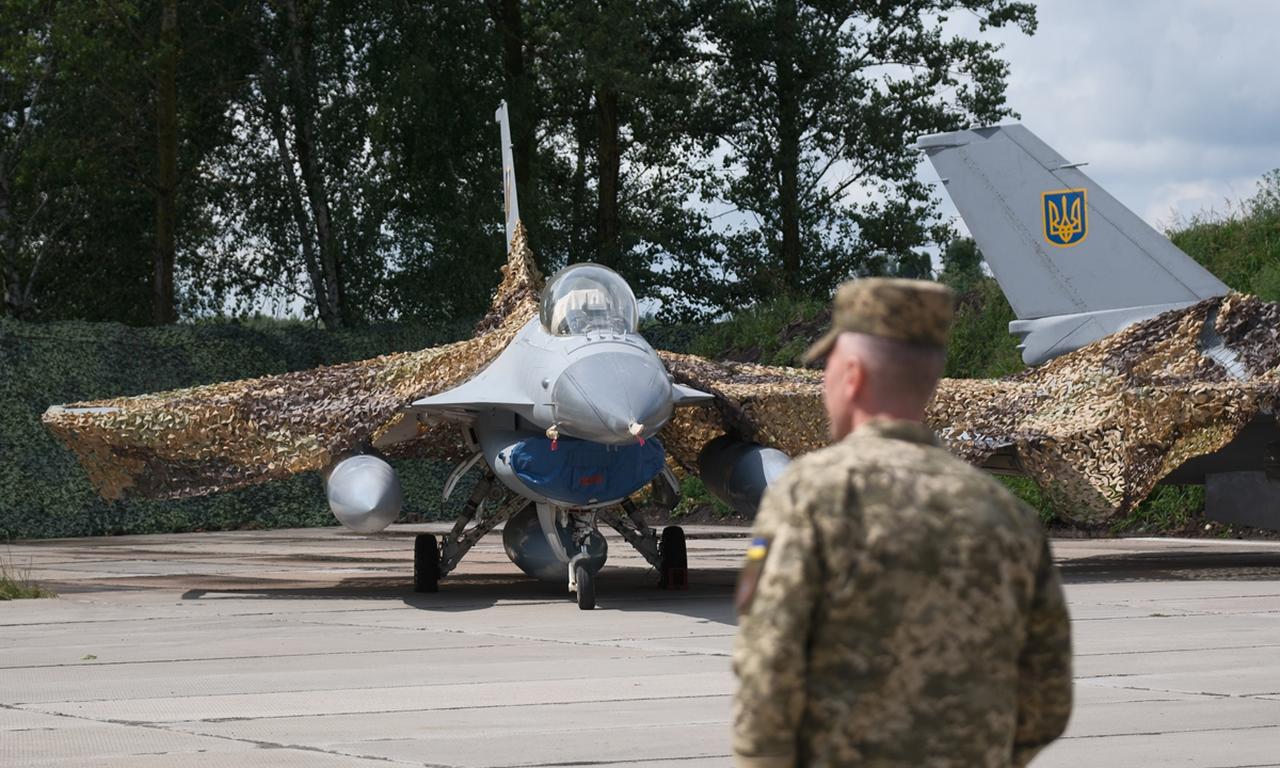 Ukrainian military member stands next to the first General Dynamics F-16 Fighting Falcon received by Ukraine on August 4, 2024, in unspecified location, Ukraine. (AFP Photo)