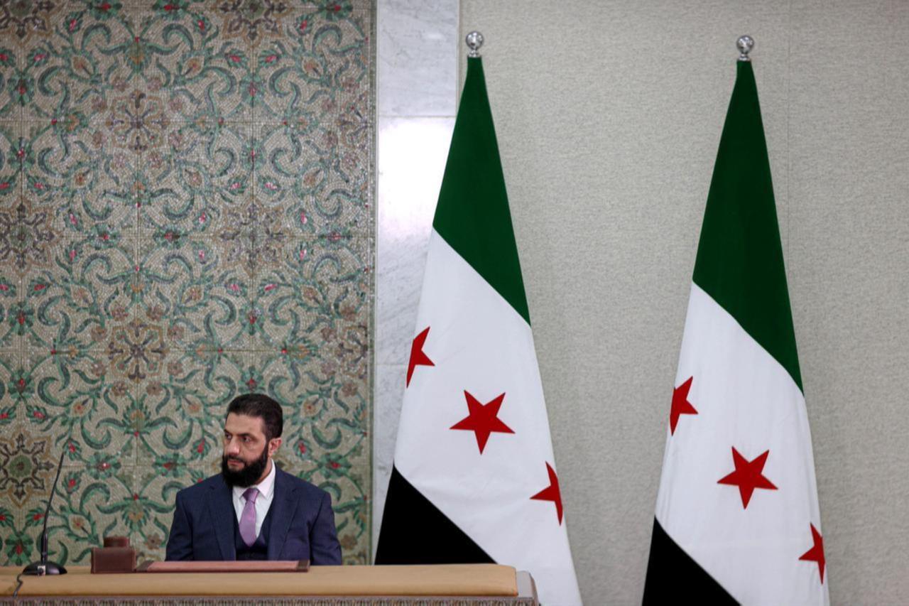Syrian President Ahmed al-Sharaa signs a declaration outlining the main provisions of the interim constitution in a ceremony held at the Peoples Palace in the capital Damascus, Syria on March 13, 2025. (AA Photo)