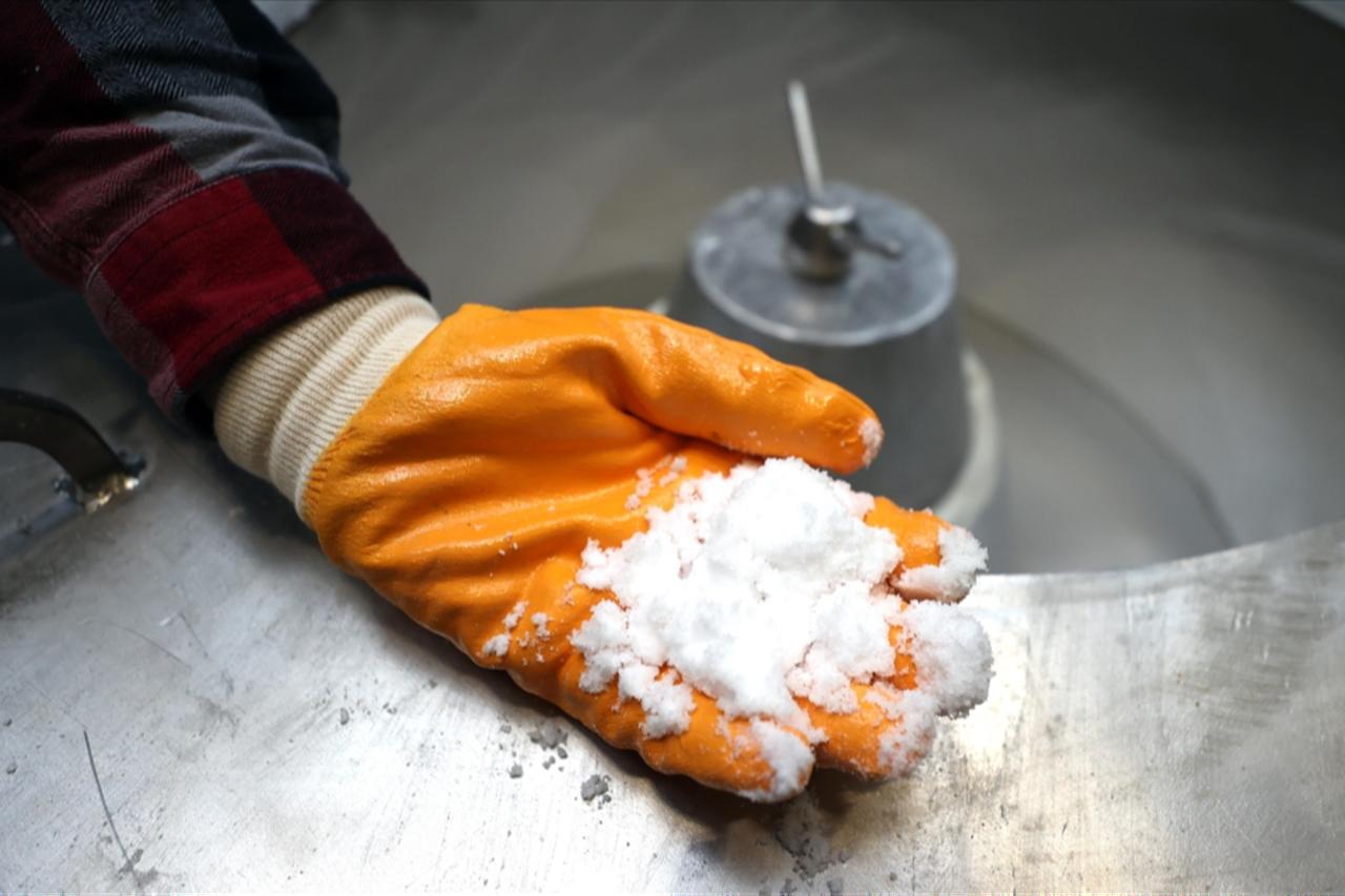 Eti Maden worker holding lithium carbonate in his hand, accessed on Aug. 22, 2025. (AA Photo)