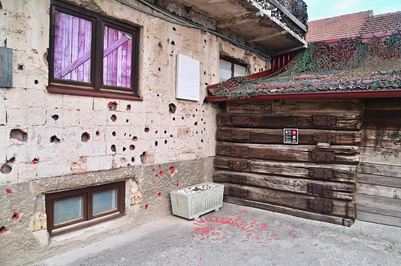 This Sarajevo rose, a patch of pink-stained concrete formed at the site of a mortar explosion during the Bosnian War, stands as a powerful symbol of both tragedy and survival. Each rose marks the loss of a life during the siege of Sarajevo, preserving the memory of those who perished, while reminding visitors of the city’s resilience, courage, and ongoing journey toward healing and reconciliation. (Adobe Stock Photo)