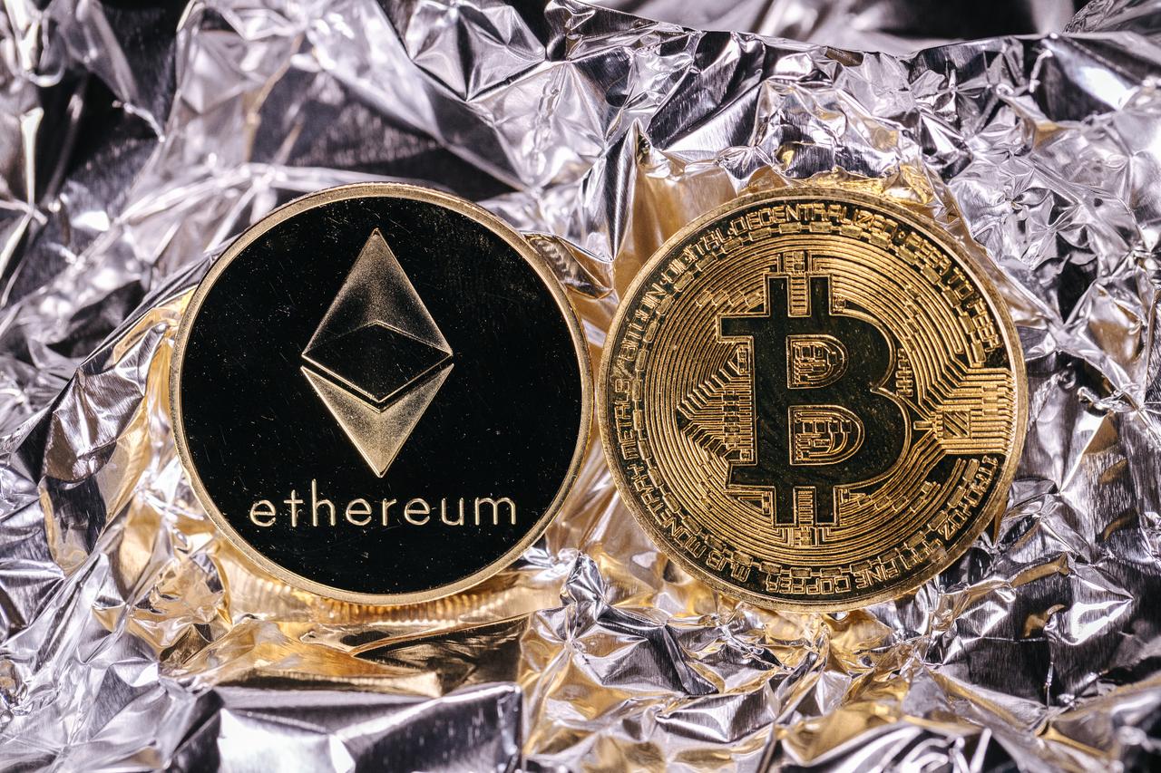 Physical representations of Ethereum and Bitcoin cryptocurrencies (Adobe Stock Photo)