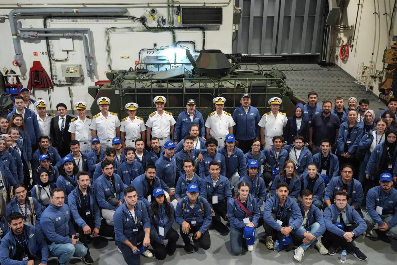 Türkiye’s first domestic warship, TCG Anadolu, sets off from Gelibolu for the ‘Victory Journey’ event, marking the 954th anniversary of the Malazgirt Victory and Victory Day celebrations; Youth and Sports Minister Osman Askin Bak and participants take photos aboard the ship, Canakkale, Türkiye, Aug. 23, 2025. (AA Photo)
