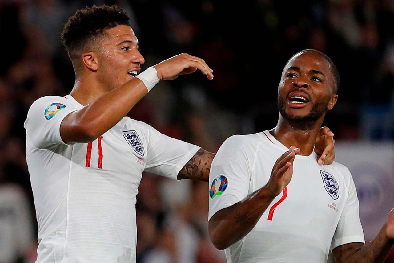 Englands midfielder Jadon Sancho (L) celebrates with Englands midfielder Raheem Sterling after scoring his second, and the teams fifth goal during the UEFA Euro 2020 qualifying Group A football match between England and Kosovo at St Marys stadium in Southampton, southern England on September 10, 2019. (AFP Photo)