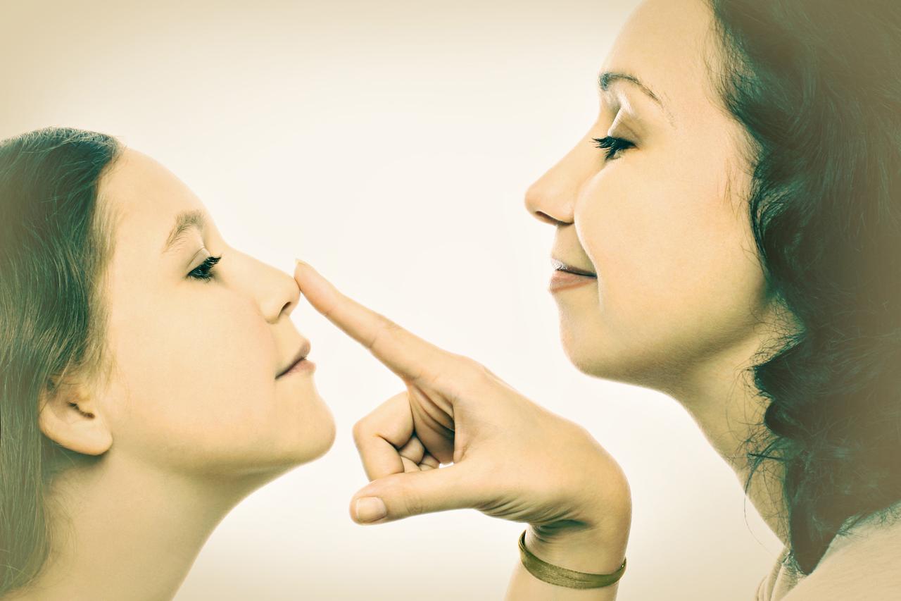 A mother holds her daughter, showing care and the connection between them. (Adobe Stock Photo)