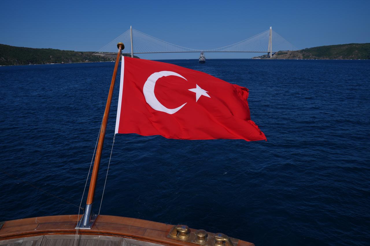 A view of the Turkish flag on TCG Savarona sailing alongside the Yavuz Sultan Selim Bridge during a parade in the Bosphorus in Istanbul, Türkiye, August 24, 2025. (AA Photo)