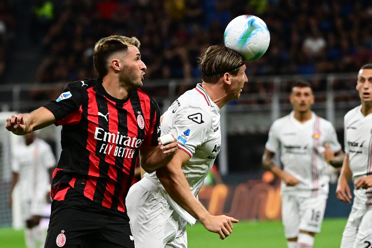 Cremonese's Italian defender #06 Federico Baschirotto fights for the ball with AC Milan's Mexican forward #07 Santiago Gimenez (L) during the Italian Serie A football match between AC Milan and Cremonese at San Siro stadium in Milan, Italy, August 23, 2025. (AFP Photo)