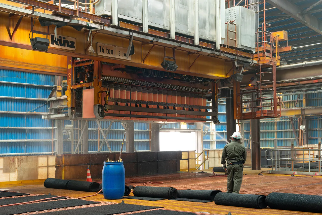A worker washing copper cathodes at an electrowinning plant in a copper mine in Chile. (Adobe Stock Photo)
