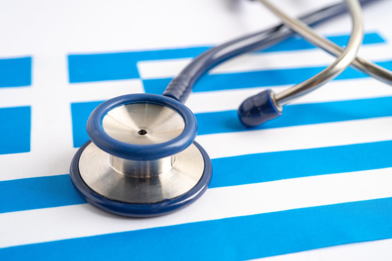 Medical stethoscope placed on the Greek national flag. (Adobe Stock Photo)