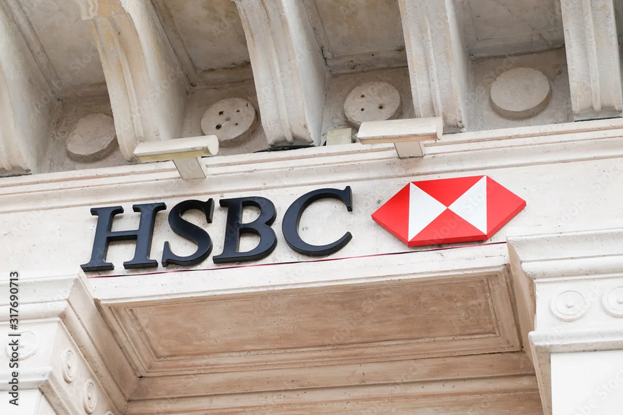 HSBC atm sign with the logo of the swiss bank agency brand in city street, ,Switzerland , (Adobe Stock Photo)
