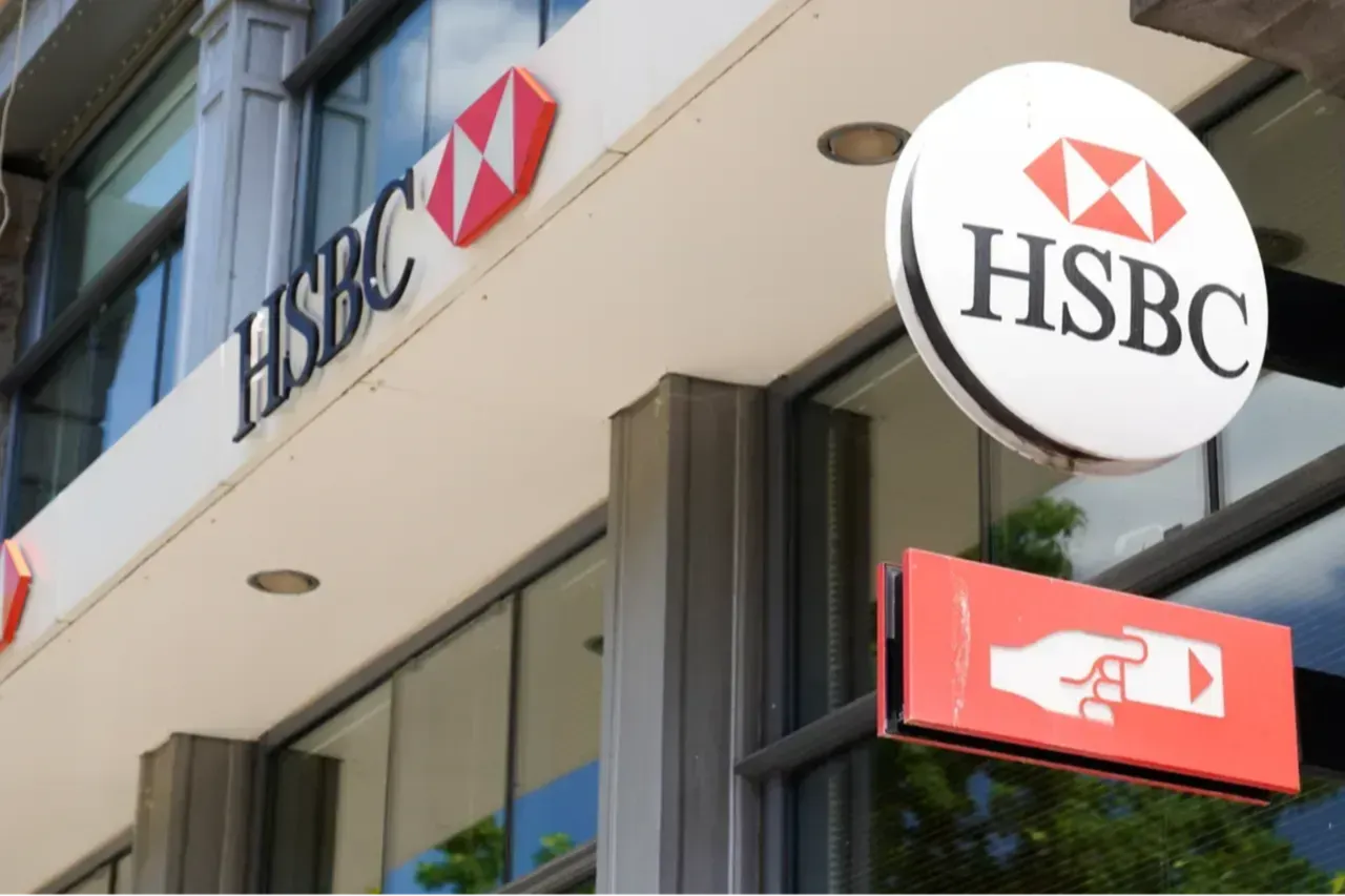 HSBC atm sign with the logo of the swiss bank agency brand in city street, ,Switzerland . (Adobe Stock Photo)