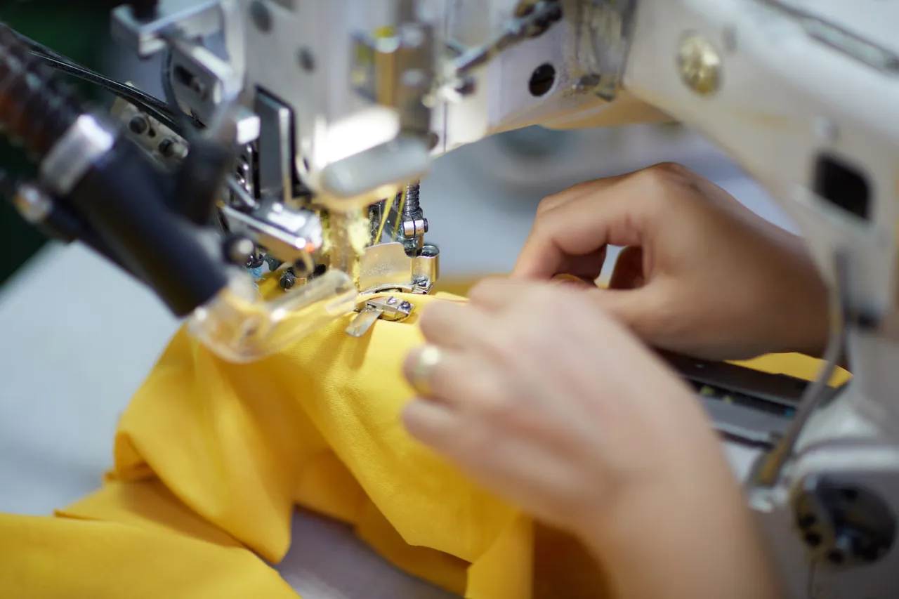 A worker sews fabric on a production line at an apparel factory in Türkiye. (Adobe Stock Photo)