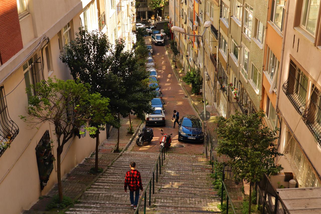 A steep residential street with stairways and parked cars in Besiktas, Istanbul, Türkiye. (Adobe Stock Photo)