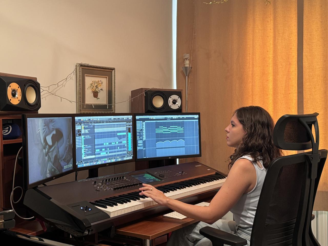 Esin Aydingoz works on a film score in her studio, blending orchestration with digital production tools, Aug. 28, 2025. (AA Photo)