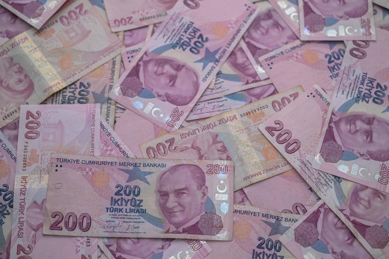 200 Turkish lira bills scattered on the table as a background in Gaziveren, Turkish Cyprus, on January 27, 2024. (Adobe Stock Photo)