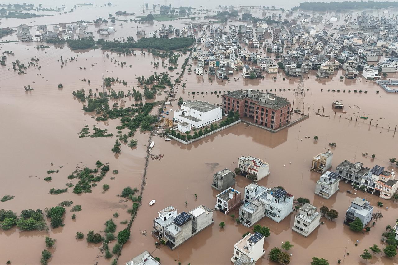 This aerial view shows partially submerged residential buildings following the overflowing of the Ravi River in Lahore on August 30, 2025. (AFP Photo)