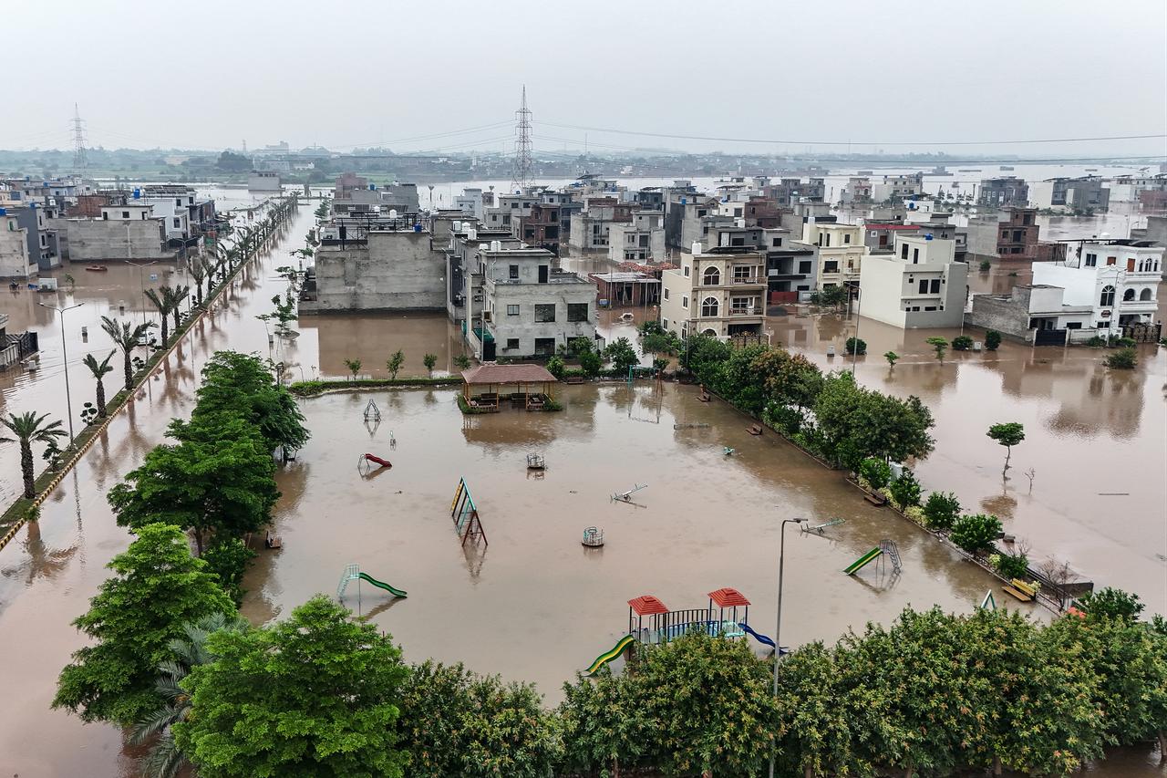 This aerial view shows partially submerged residential buildings following the overflowing of the Ravi River in Lahore on August 30, 2025. (AFP Photo)