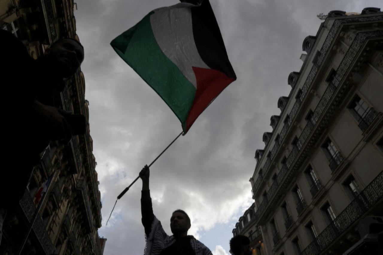 A protestor holds up a Palestinian flag during a demonstration called by French organisation  France Palestine Solidarite  in Paris, France, May 27, 2024. (AFP Photo)