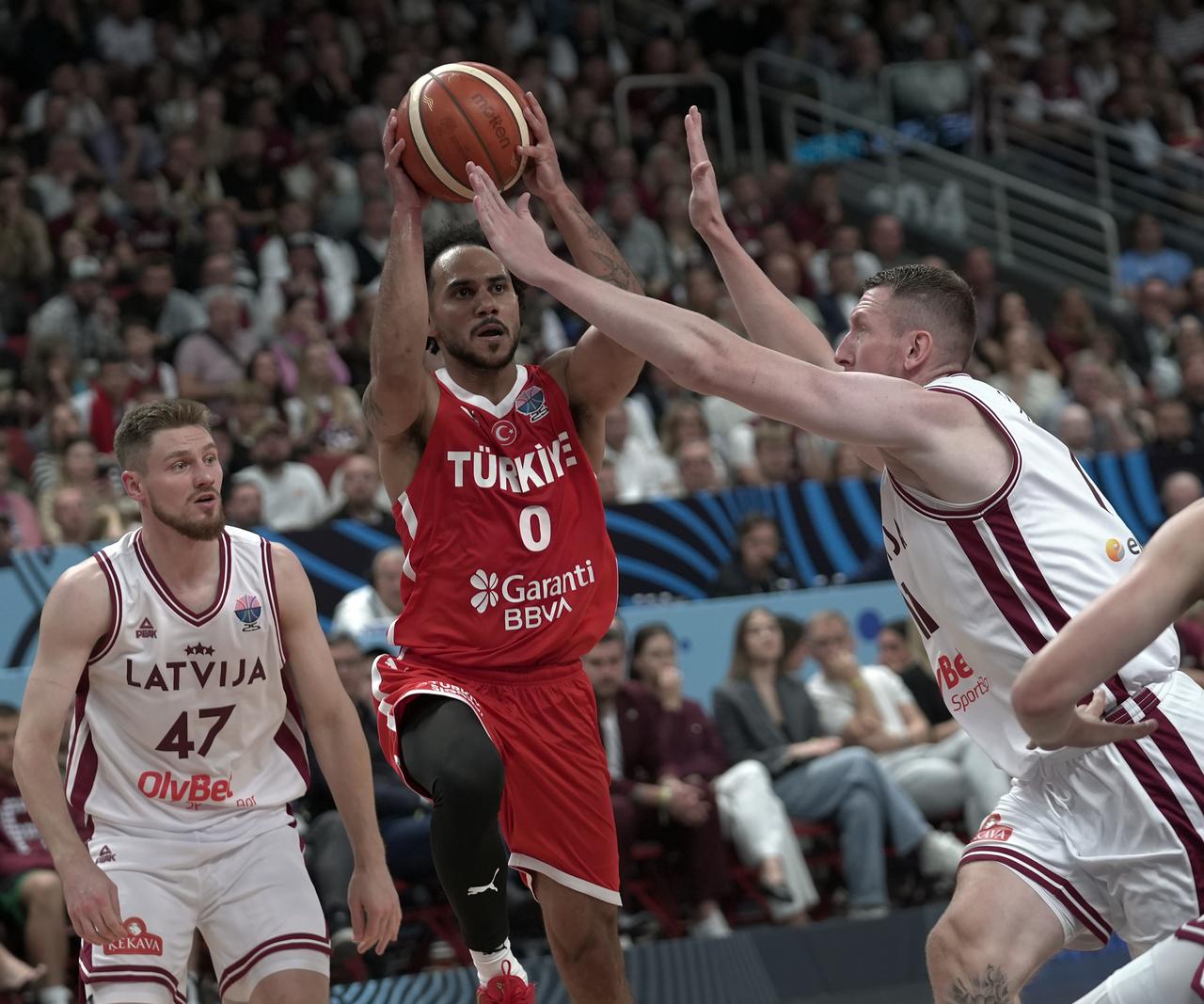 Shane Larkin of Türkiye in action against Rolands Smits of Latvia during the FIBA EuroBasket 2025 Group A 1st week match between Latvia and Türkiye, Riga, Latvia, August 27, 2025.